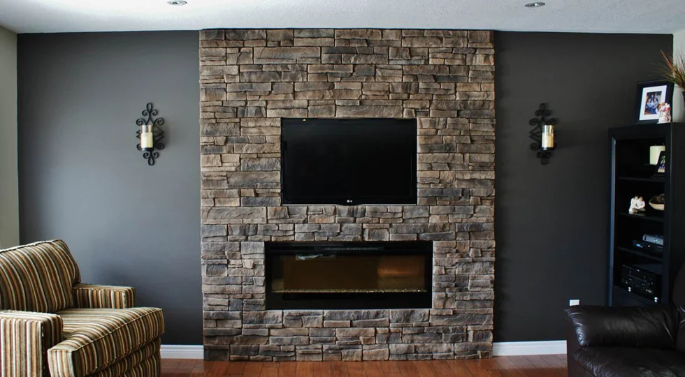 Dark accent wall surrounding a stone fireplace